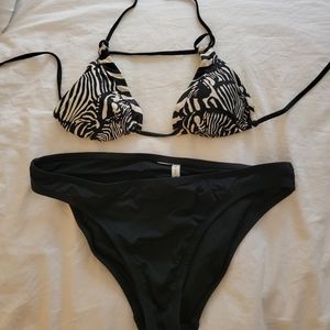 Size Medium black and white zebra print bikini top with black bottom.